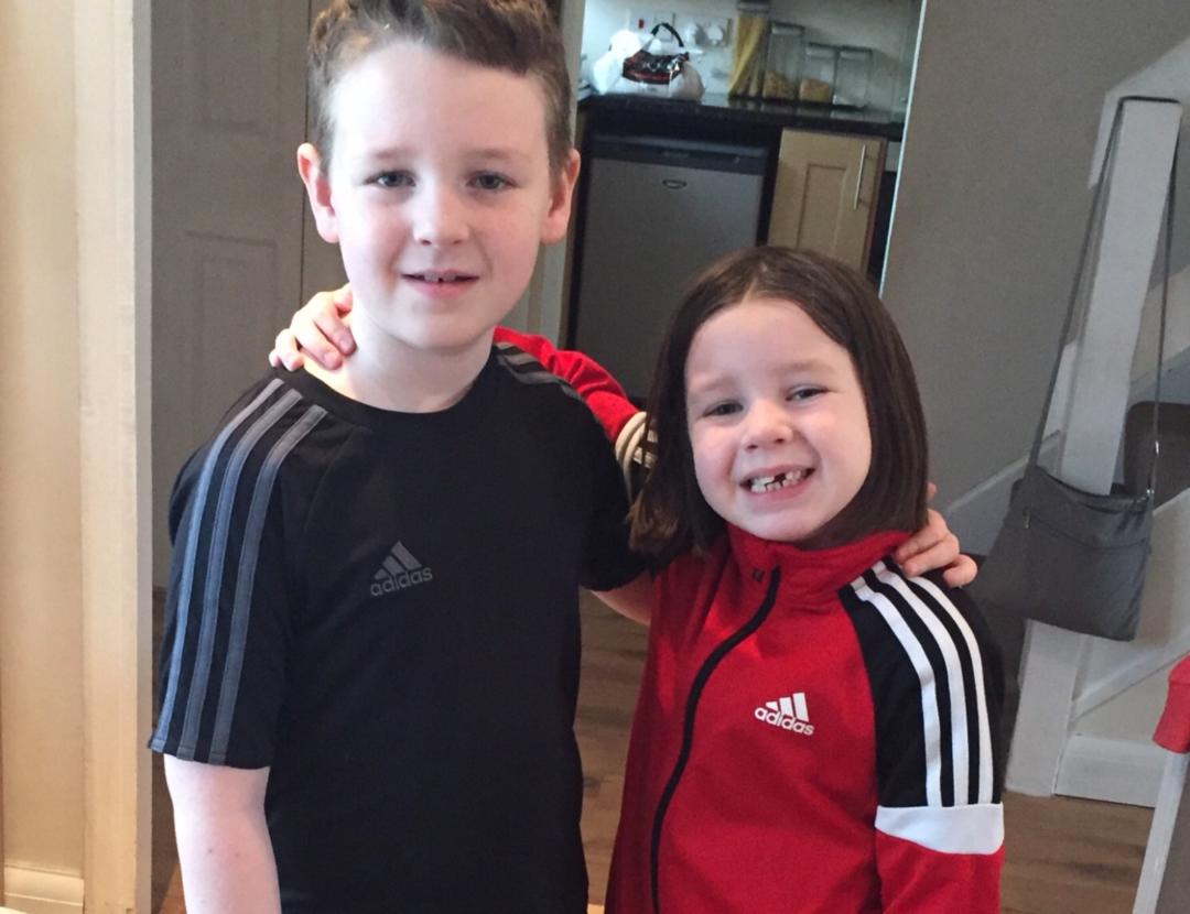 Boy and a girl in football kit