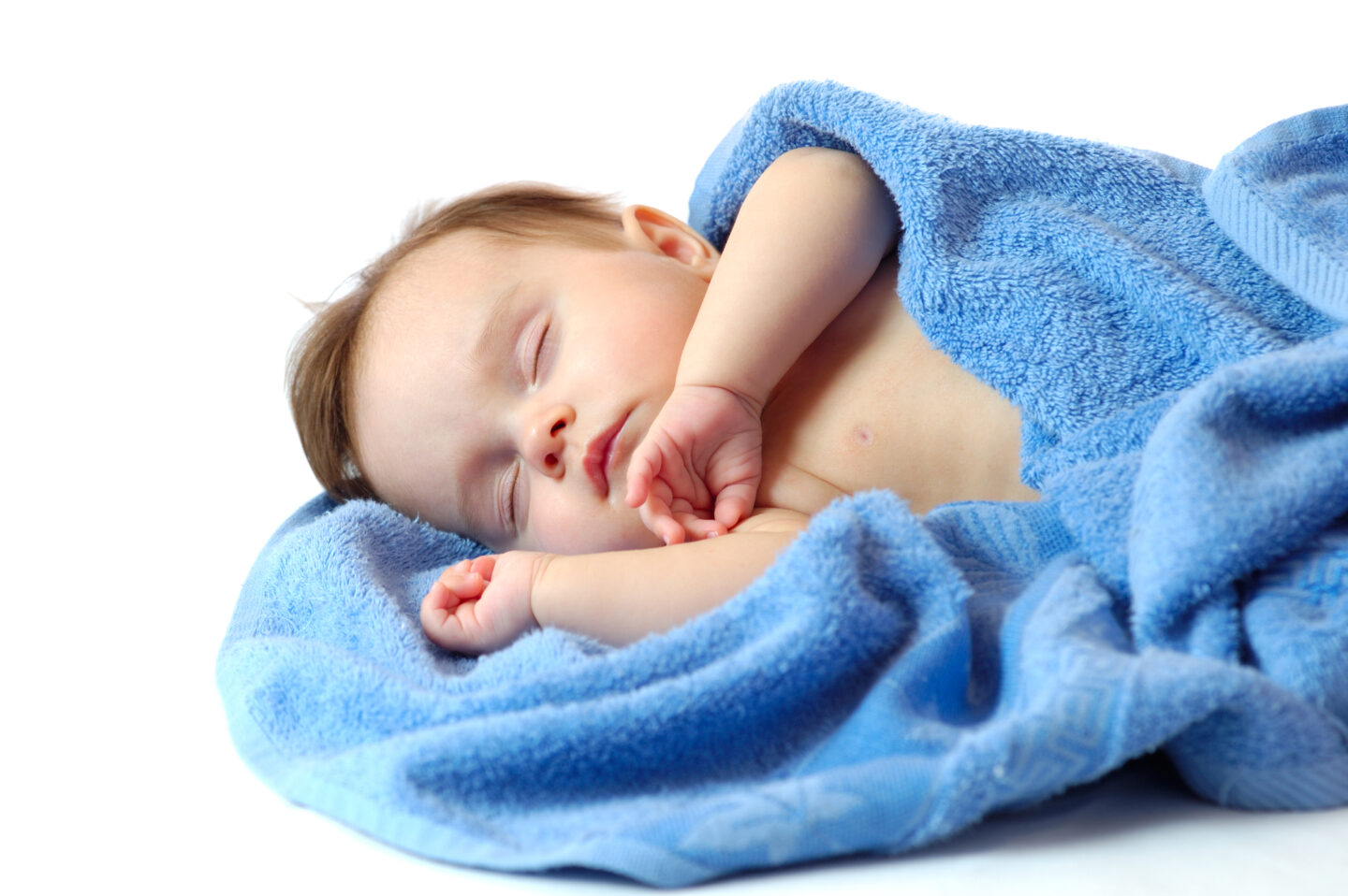 portrait of a sweet sleeping little boy on blue towel
